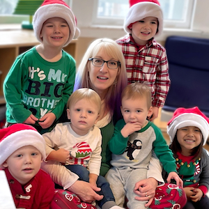 Provider with children wearing Santa hats during the holidays