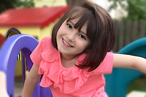 Girl smiling while going down a slide