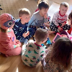 Children sitting together in a family child care setting